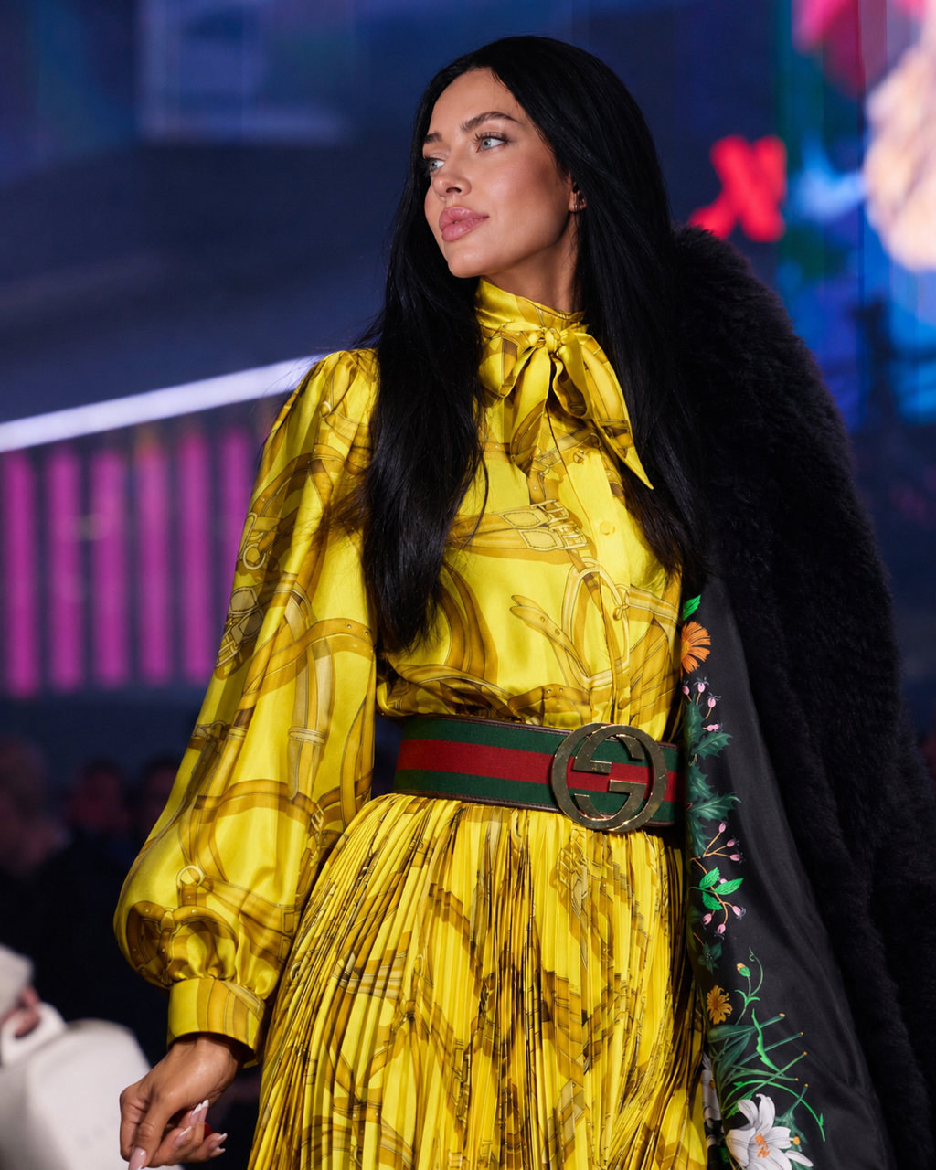 Model in yellow Gucci dress with signature green-red Gucci belt on the runway